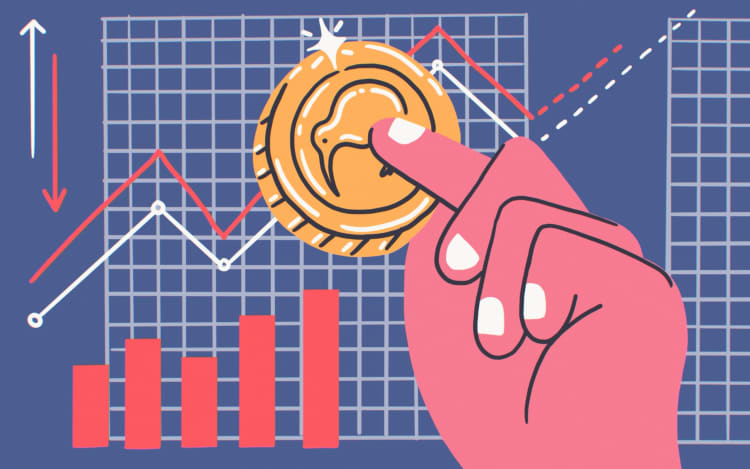 Kiwi coin in hand and investment charts.