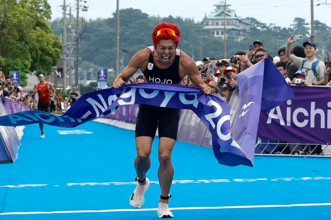 Asian Games - Aichi-Nagoya 2026 - Triathlon - Gamagori City Triathlon Venue, Gamagori, Japan - September 20, 2026 Japan's Takumi Hojo celebrates as he crosses the line to win the gold medal in the men's individual final REUTERS/Bryan Foo