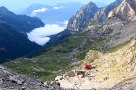 View from high in the mountains down a valley with clouds below.