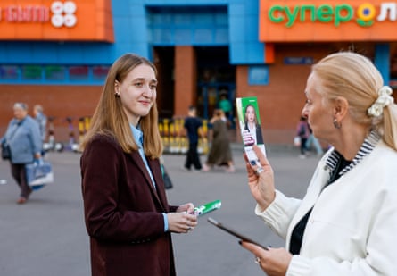 Young woman handing out flyers