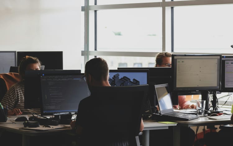 Workers at desks in an office.