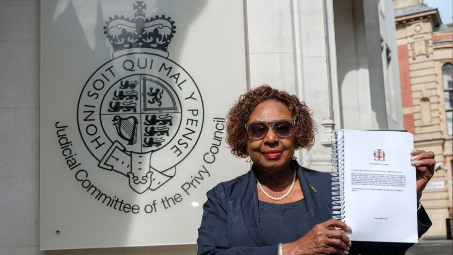 Culture Minister Olivia Grange stands in front of the Judicial Committee of the Privy Council building in London, England, holding the historic reparations petition document filed to King Charles III.