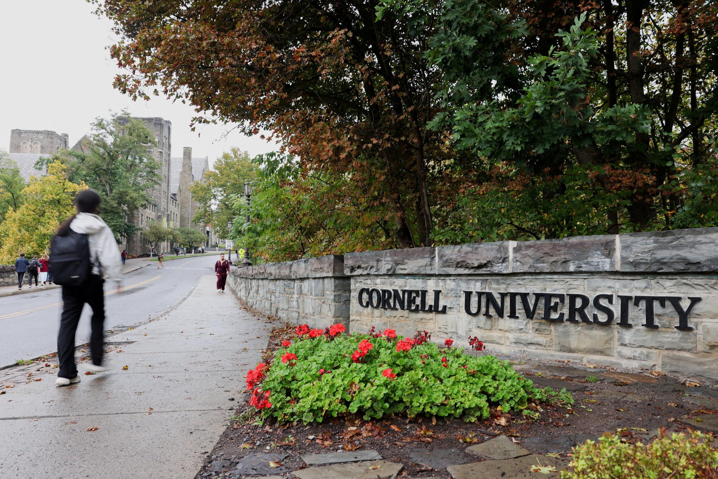 A student walks by a sign at the entrance of Cornell University in Ithaca, New York, US, October 1, 2026.