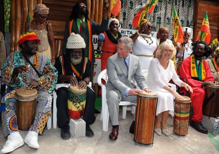 King charles and with camilla playing drums with Jamaican musicians