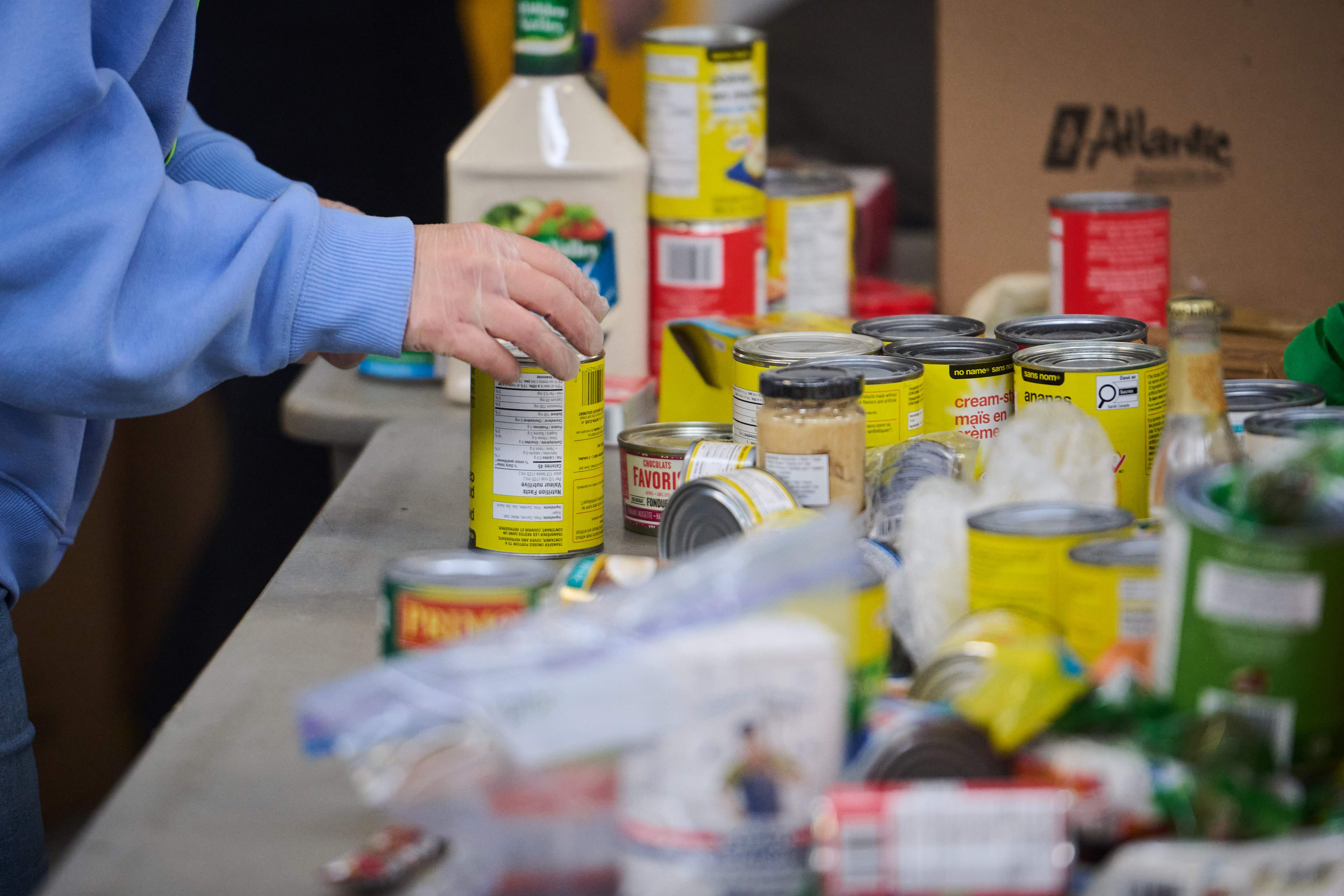 Volunteers sort and pack food donations at the Daily Bread Food Bank's spring public food sort in Toronto, on Saturday, April 4, 2026. THE CANADIAN PRESS/Sammy Kogan